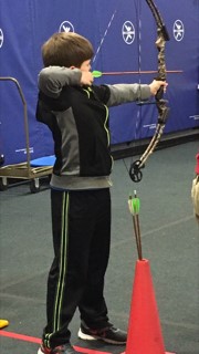 boy shooting bow at the target