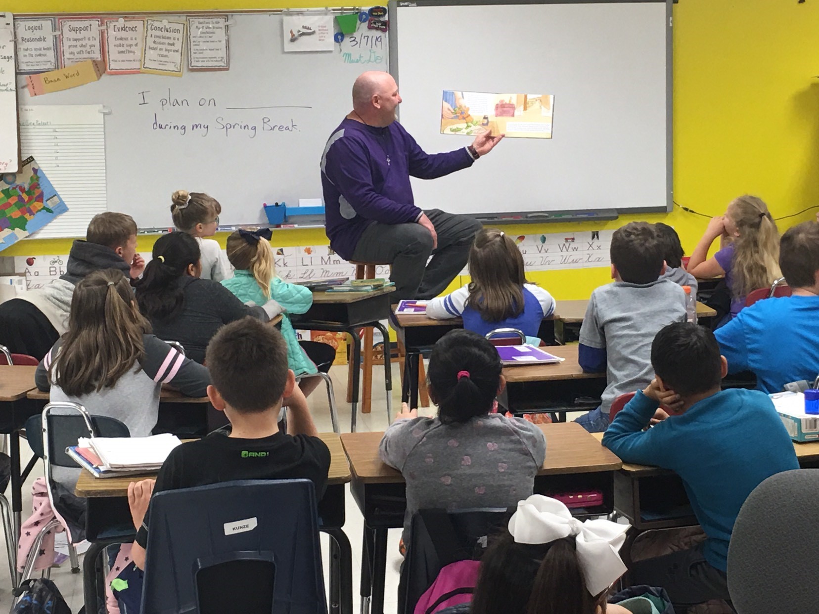 Volunteers read to elementary classes Coach McCollum reads to 3rd grade