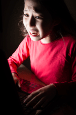 Girl crying at computer